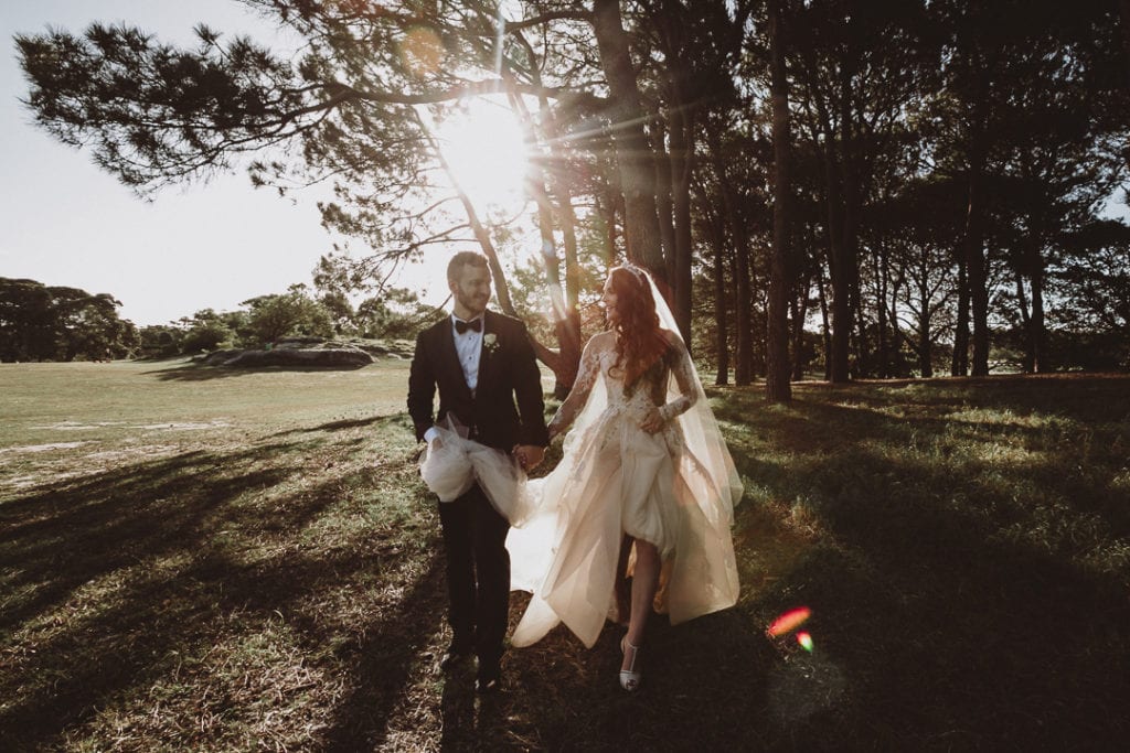 bride and groom walking in forrest