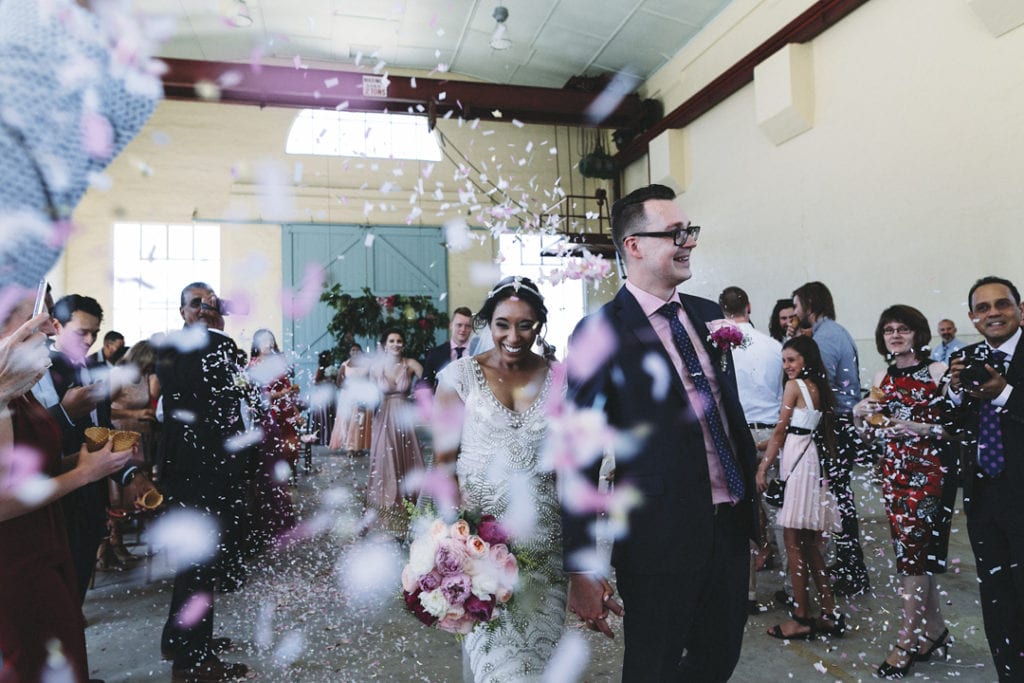 bride and groom exit ceremony with confetti