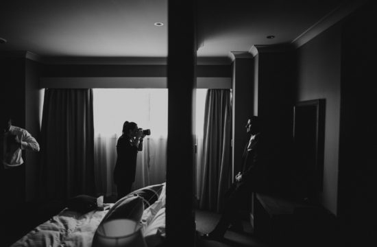 photographer taking photo of groom