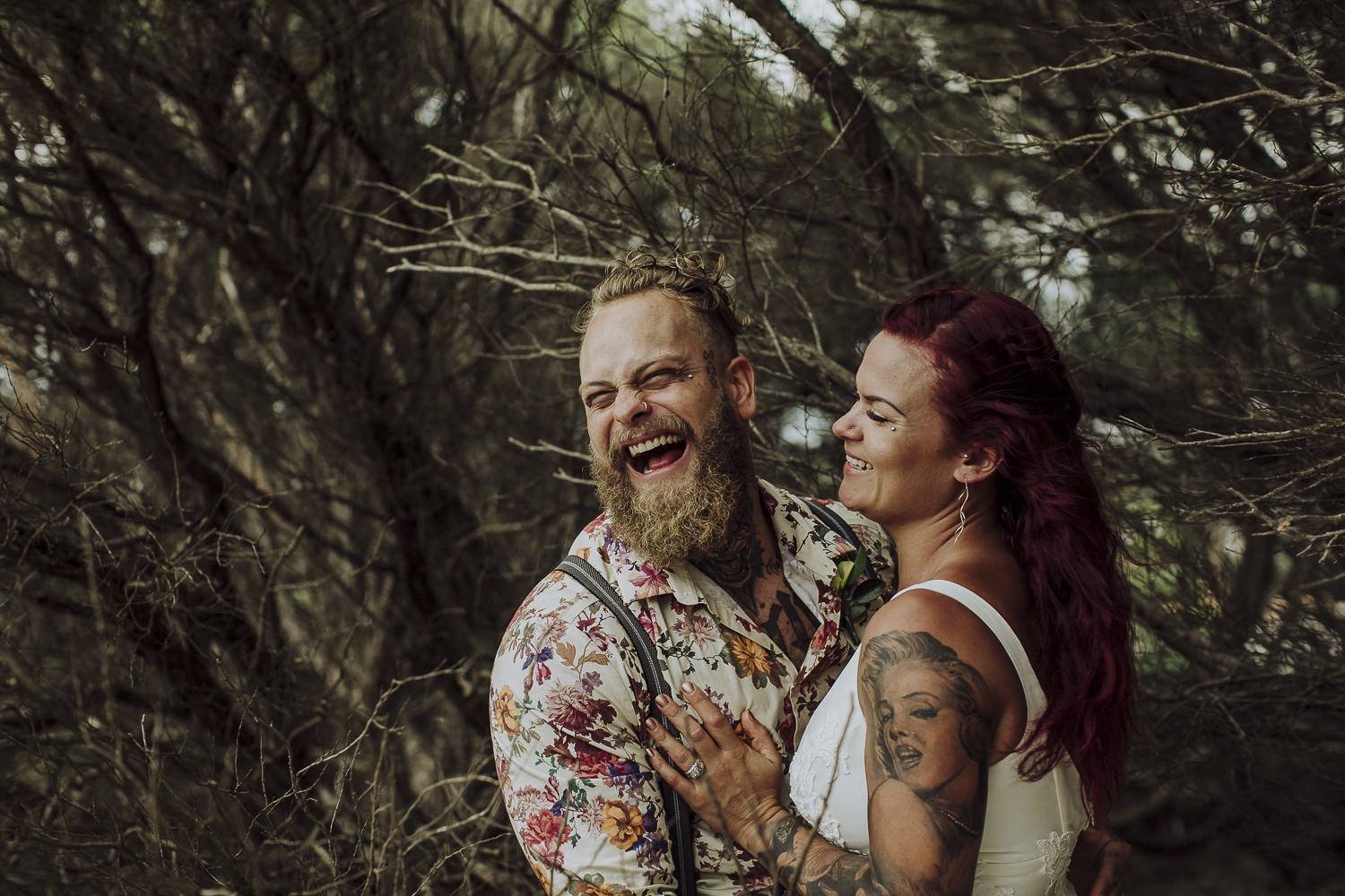 beared groom with tats laughing
